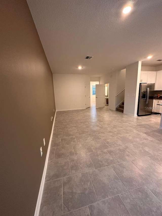 spare room featuring a textured ceiling