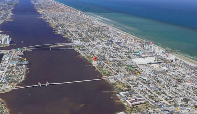 drone / aerial view featuring a water view and a view of the beach