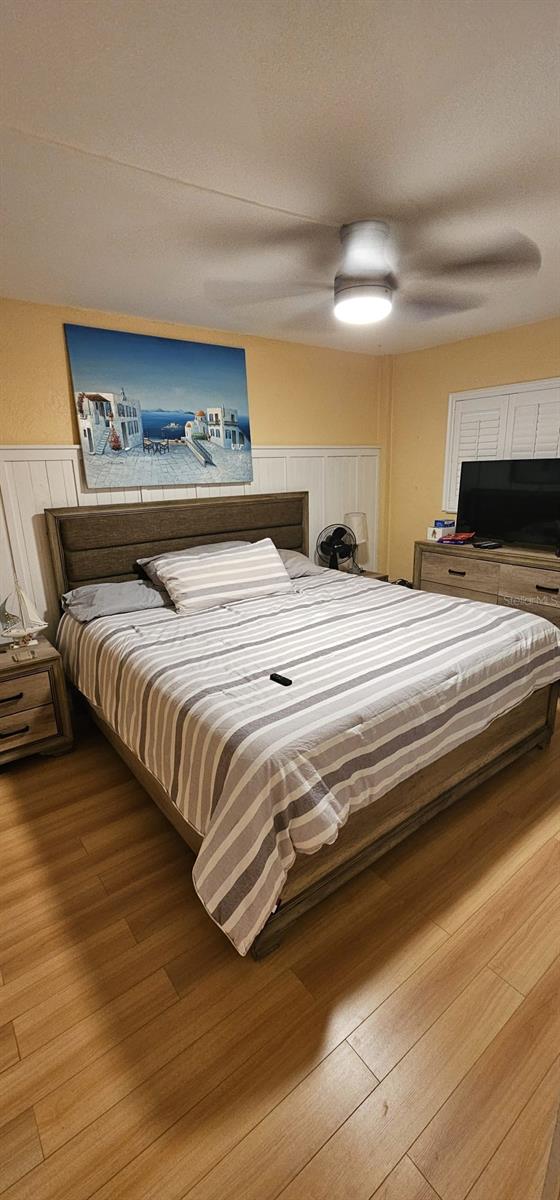 bedroom featuring ceiling fan and hardwood / wood-style flooring