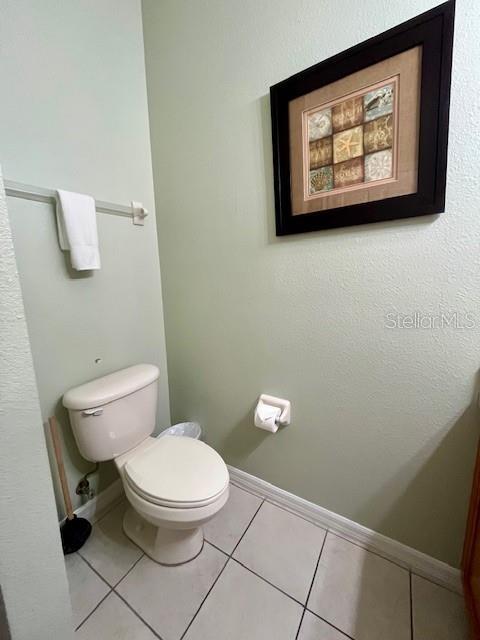 bathroom with tile patterned flooring and toilet