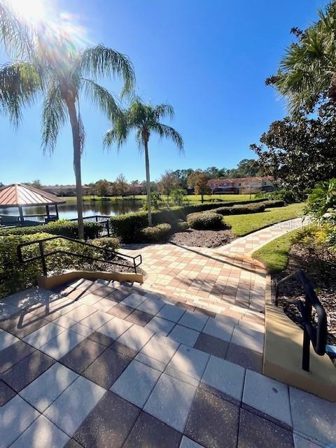 surrounding community featuring a patio and a water view