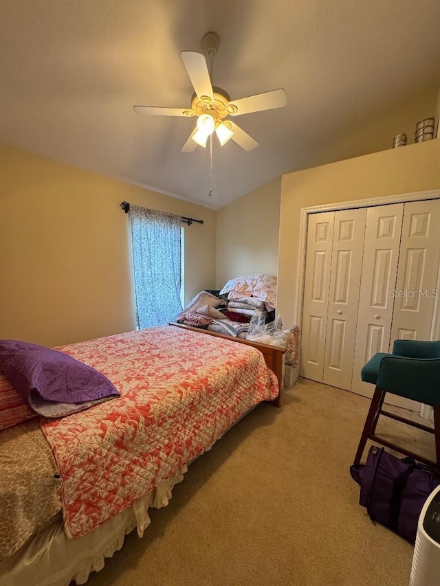 bedroom with ceiling fan, light colored carpet, and a closet