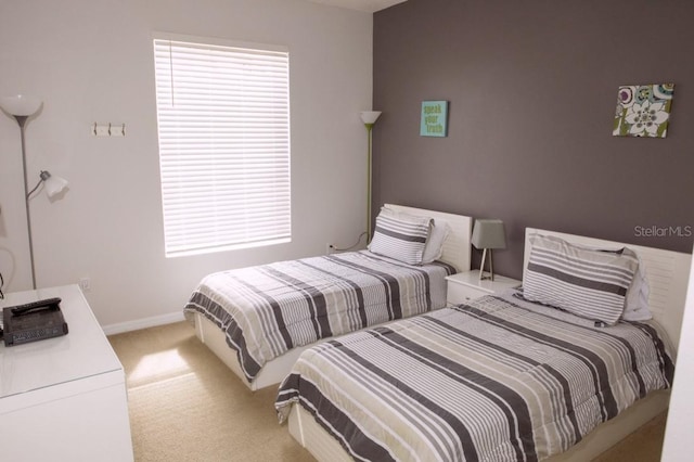 bedroom featuring light carpet