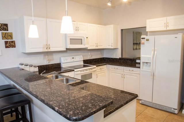 kitchen featuring kitchen peninsula, white cabinetry, and white appliances