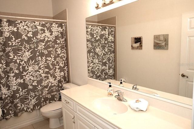 bathroom with tile patterned flooring, vanity, and toilet