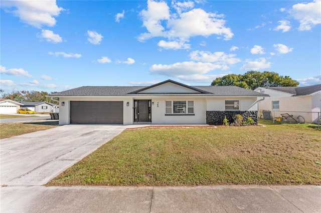 ranch-style home with a front yard and a garage