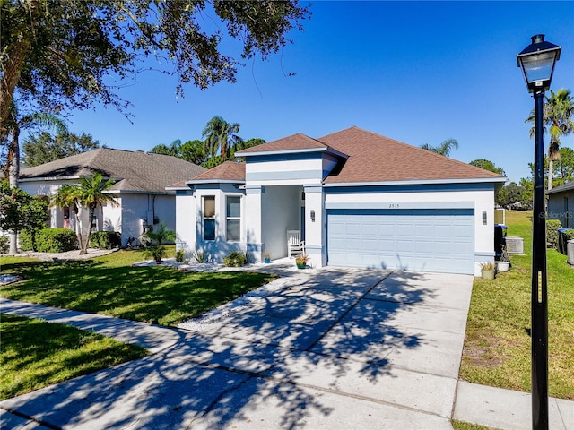 view of front of home with a garage and a front lawn