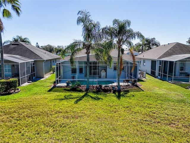 back of house featuring a lanai and a lawn