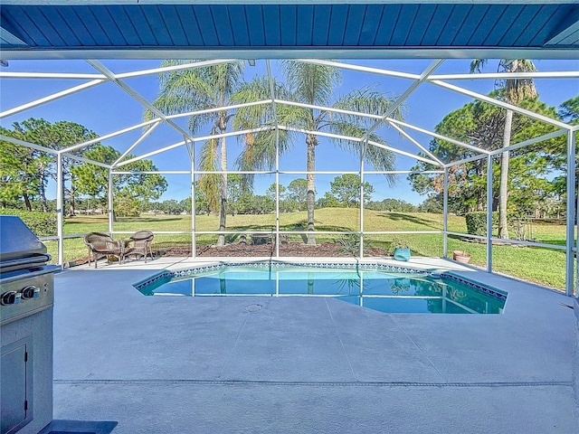 view of pool with a lawn, a patio area, and glass enclosure