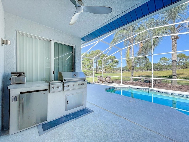 view of patio / terrace with an outdoor kitchen, ceiling fan, glass enclosure, and grilling area