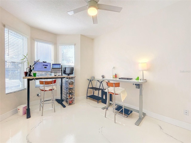 office with ceiling fan, a textured ceiling, and concrete floors