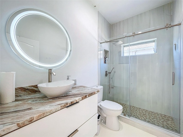 bathroom with vanity, toilet, and walk in shower