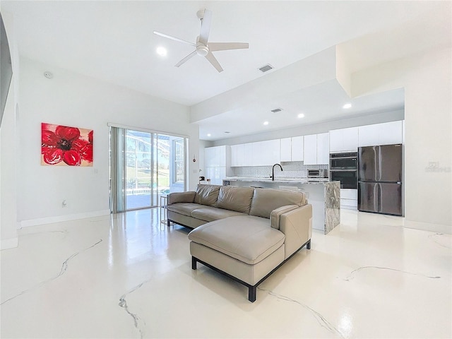 living room with ceiling fan and sink