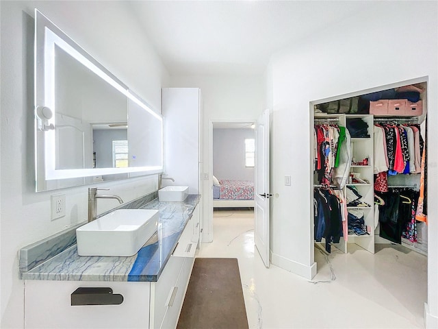 bathroom with concrete flooring and vanity