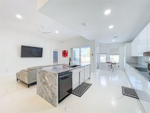 kitchen with white cabinetry, sink, an island with sink, and black appliances