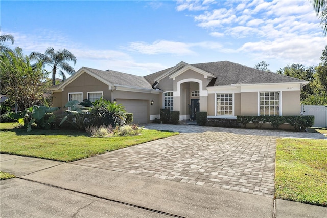 single story home with a front yard and a garage