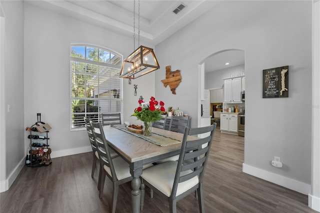 dining room with a chandelier and dark hardwood / wood-style floors