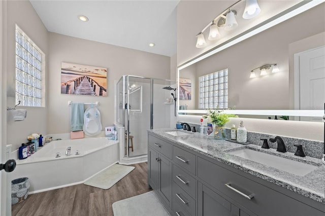 bathroom with vanity, wood-type flooring, and independent shower and bath