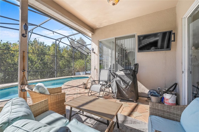 view of patio / terrace featuring outdoor lounge area and glass enclosure