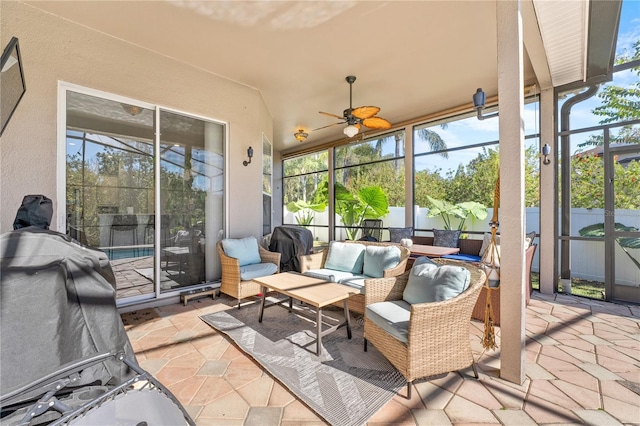 sunroom / solarium with ceiling fan and vaulted ceiling