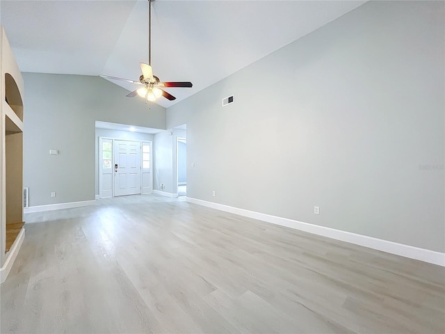 unfurnished room with light wood-type flooring, high vaulted ceiling, and ceiling fan