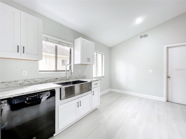 kitchen with white cabinets, light stone counters, vaulted ceiling, sink, and dishwasher