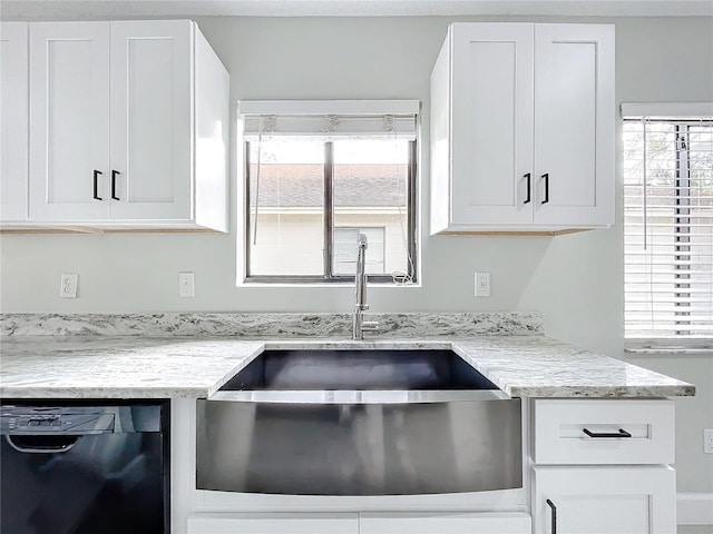 kitchen with dishwasher, white cabinets, a wealth of natural light, and sink