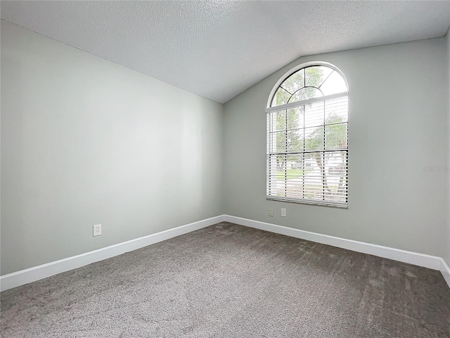 unfurnished room with carpet floors, a textured ceiling, and vaulted ceiling