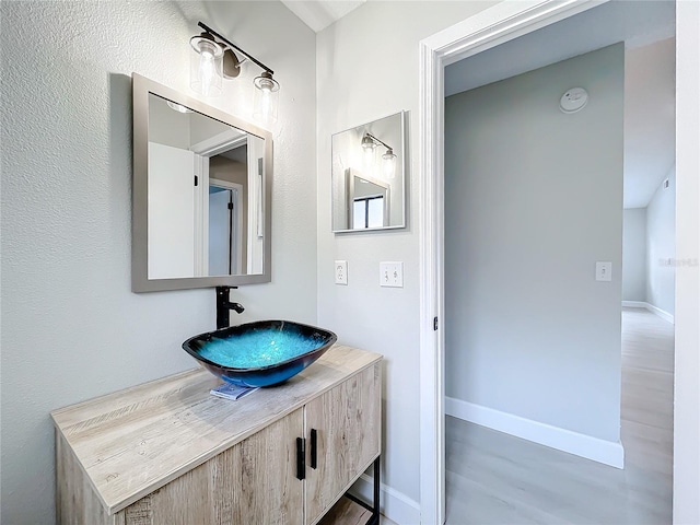 bathroom with hardwood / wood-style flooring and vanity