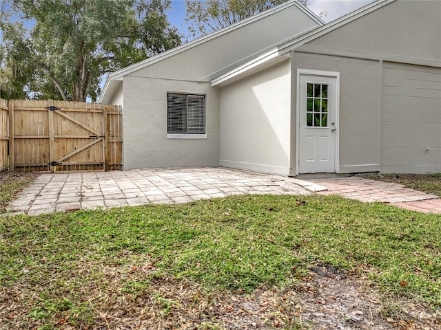 rear view of property featuring a lawn