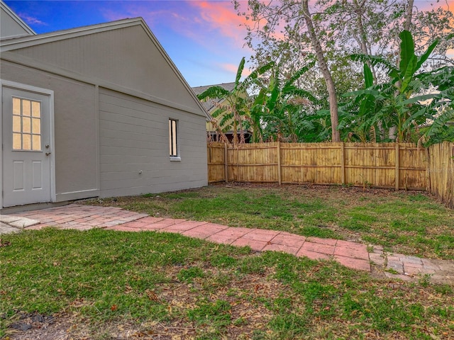 view of yard at dusk