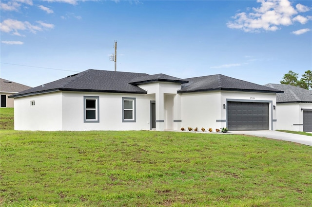 prairie-style house featuring a garage and a front lawn