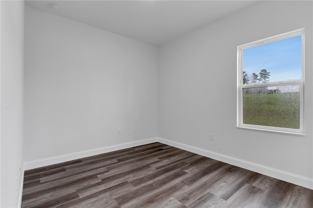 unfurnished room with dark hardwood / wood-style floors