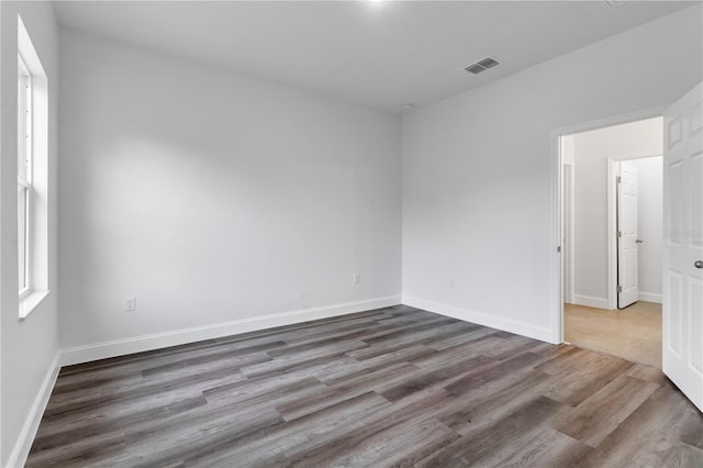 spare room with hardwood / wood-style floors