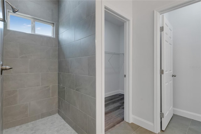 bathroom featuring tiled shower and tile patterned floors