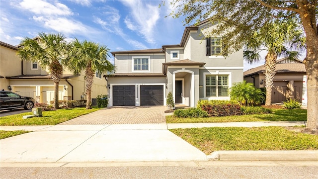 view of front of home with a front lawn and a garage