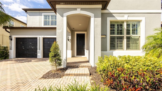 doorway to property with a garage