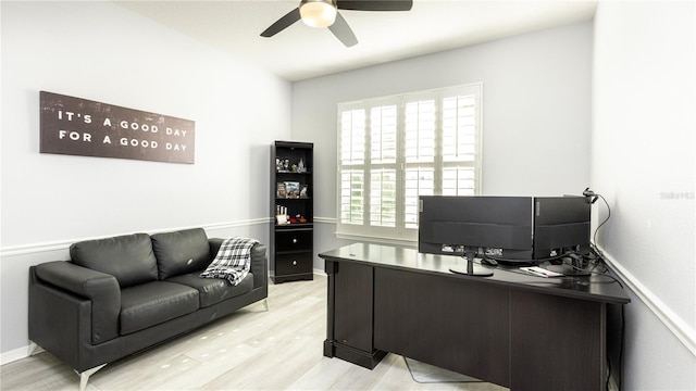 office with ceiling fan and light hardwood / wood-style flooring