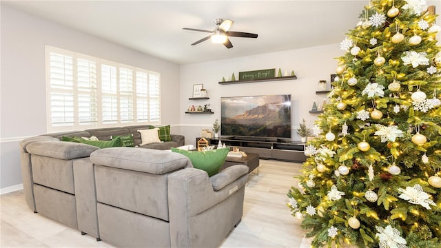 living room with ceiling fan and light hardwood / wood-style flooring