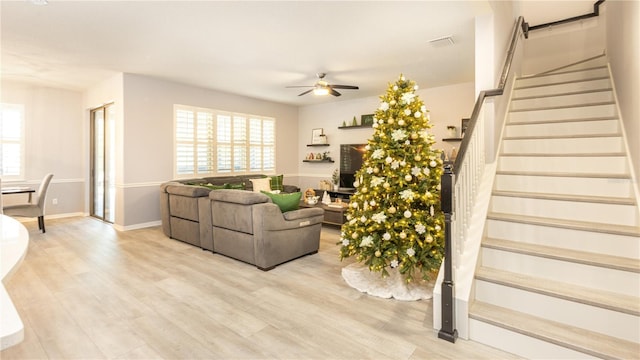 living room with ceiling fan and light hardwood / wood-style flooring