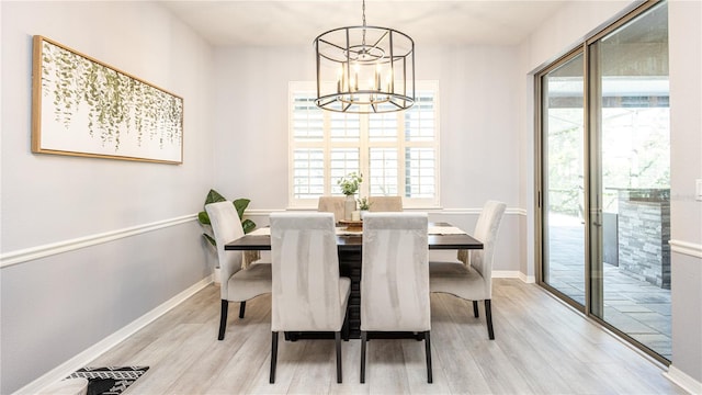 dining space with a chandelier and light hardwood / wood-style floors