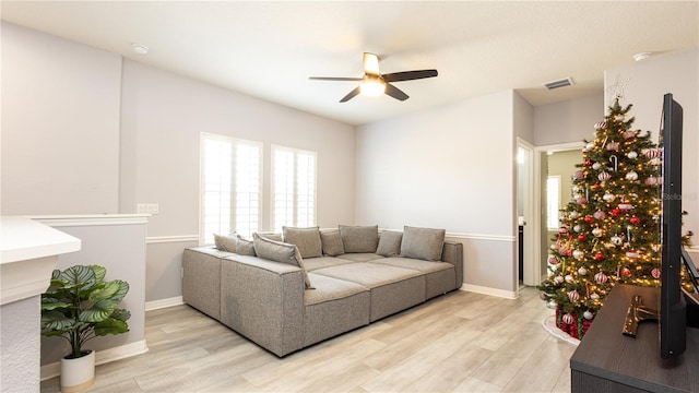 living room featuring ceiling fan and light wood-type flooring