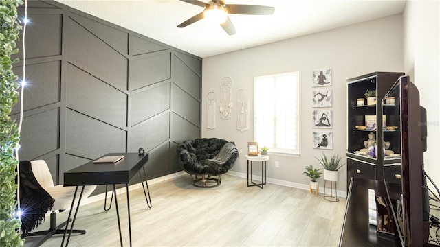 sitting room featuring ceiling fan and light wood-type flooring