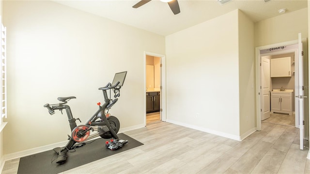 exercise area featuring light hardwood / wood-style flooring, ceiling fan, and sink