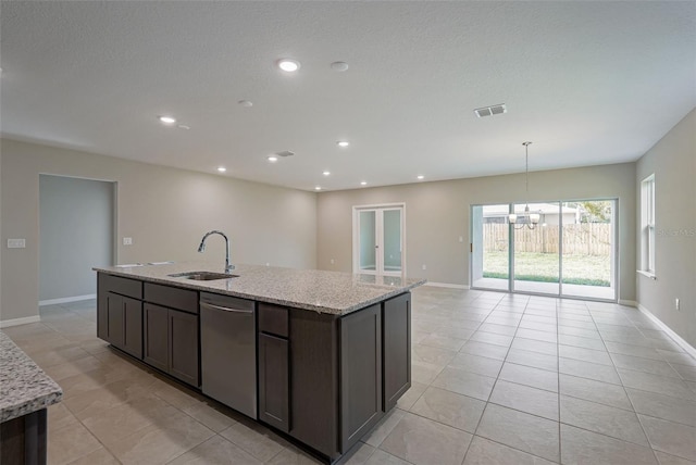 kitchen featuring light stone countertops, stainless steel dishwasher, dark brown cabinets, sink, and a chandelier