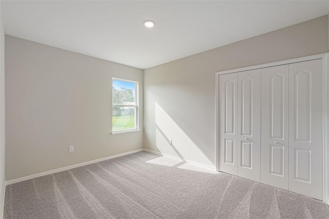 unfurnished bedroom with carpet flooring and a closet