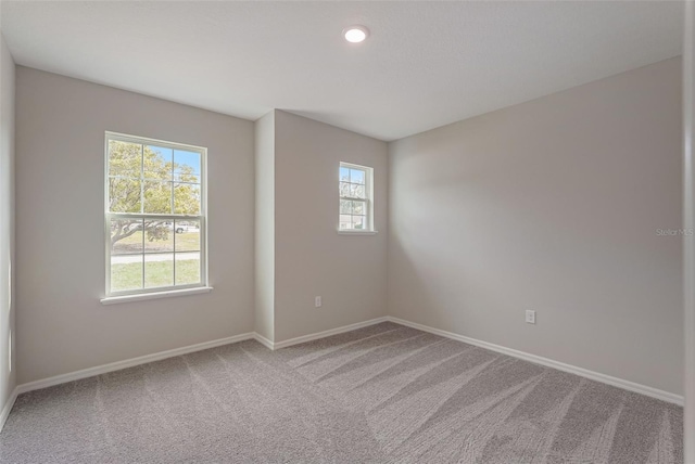 carpeted empty room featuring plenty of natural light