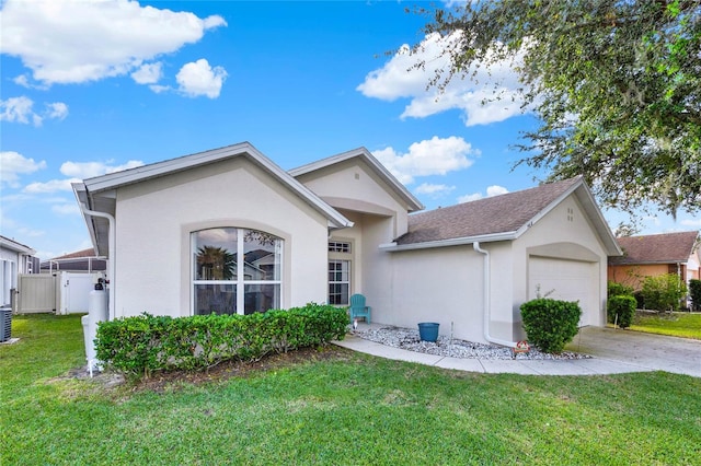 view of front of property with cooling unit, a garage, and a front lawn