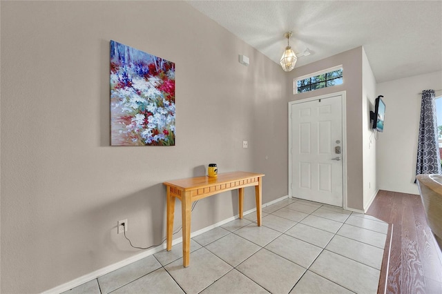 tiled entrance foyer with a textured ceiling