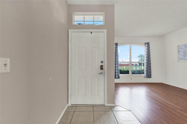 entrance foyer featuring a textured ceiling and light wood-type flooring